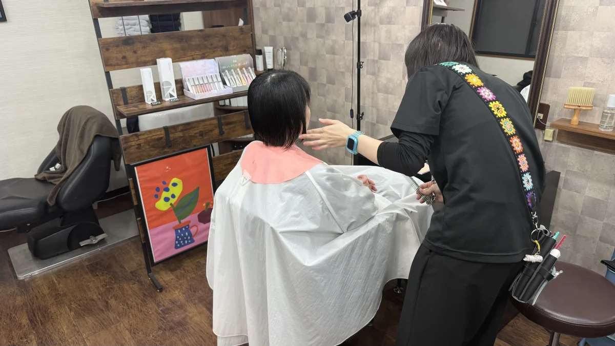 美容室で髪を切る女性